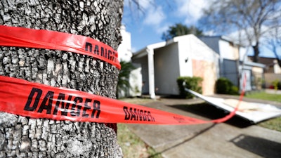 Red 'danger' tape circles a damaged home on Bridgeland Lane in Houston, Sunday, Jan. 26, 2020, after the Watson Grinding Manufacturing explosion early Friday morning.
