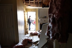 Houston Fire Chief Samuel Peña talks with Hortensia Lima, whose home was seriously damaged and deemed uninhabitable on Stanford Court in Houston, Sunday, Jan. 26, 2020, after the Friday morning explosion at the Watson Grinding Manufacturing plant.