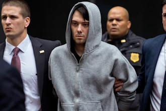 In this Dec. 17, 2015, file photo, Martin Shkreli, center, the former hedge fund manager under fire for buying a pharmaceutical company and ratcheting up the price of a life-saving drug, is escorted by law enforcement agents in New York after being taken into custody following a securities probe. State and federal authorities sued the imprisoned drug entrepreneur Monday, Jan. 27, 2020, over business tactics that helped make him the bad-boy face of profiteering in the pharmaceuticals industry, seeking to bar the so-called 'Pharma Bro' from the industry for life.