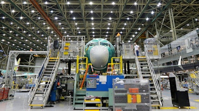 In this Dec. 7, 2015 file photo, a Boeing 737 MAX airplane being built is shown on the assembly line in Renton, Wash. Orders to U.S. factories for big-ticket manufactured goods rose in December 2019 as a big jump in demand for military aircraft offset a sharp decline in commercial aircraft. Demand for commercial aircraft fell a sharp 74.7 percent, reflecting the struggle Boeing has had getting its troubles Boeing has had with its troubled 737 Max plane following two fatal crashes.