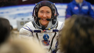 In this Thursday, March 14, 2019 file photo, U.S. astronaut Christina Koch, member of the main crew of the expedition to the International Space Station (ISS), speaks with her relatives through a safety glass prior the launch of Soyuz MS-12 space ship at the Russian leased Baikonur cosmodrome, Kazakhstan. Koch told The Associated Press on Tuesday, Jan. 28, 2020, her 319th consecutive day in space _ that taking part in the first all-female spacewalk was the highlight of her mission. She's been living on the International Space Station since March and returns to Earth on Feb. 6, landing in Kazakhstan with two colleagues aboard a Russian capsule.