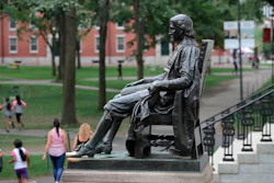 In this Aug. 13, 2019, file photo, the statue of John Harvard sits in Harvard Yard at Harvard University in Cambridge, Mass. Federal prosecutors on Tuesday, Jan. 28, 2020, charged Harvard University professor Charles Leiber, chair of the department of chemistry and chemical biology, with lying to officials about his involvement with a Chinese government-run recruitment program through which he received tens of thousands of dollars.