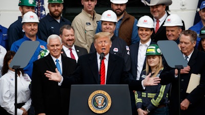 President Donald Trump speaks during an event at the White House to sign a new North American trade agreement with Canada and Mexico, Wednesday, Jan. 29, 2020, in Washington. The President is joined by Vice President Mike Pence, left, and U.S. Trade Representative Robert Lighthizer, right, and others.