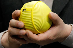 Hyun-Suk Kim, president and CEO of the Consumer Electronics Division at Samsung, holds Ballie, an AI rolling robot during a Samsung keynote before the CES tech show, Monday, Jan. 6, 2020, in Las Vegas.