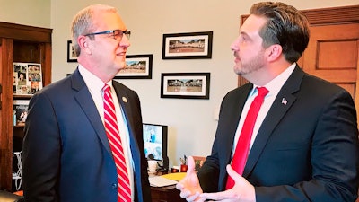 In this Jan. 30, 2019 photo provided by Sen. Kevin Cramer's office, Tommy Fisher, right, talks with Sen. Kevin Cramer, R-N.D., at the lawmaker's office in Washington, D.C. Fisher runs Fisher Sand & Gravel, the North Dakota company that won a $400 million contract to build part of the border wall. But the contract is now being audited over concern it may not meet requirements.