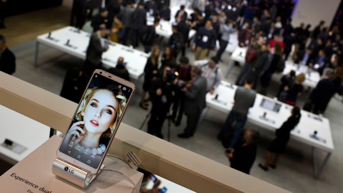In this Feb. 27, 2017 file photo, people crowd at the LG stand during the Mobile World Congress wireless show in Barcelona, Spain.