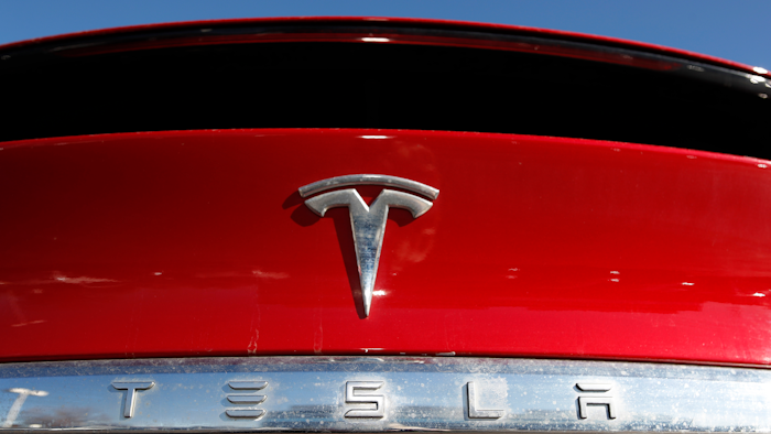 In this Feb. 2, 2020 file photograph, the company logo sits on an unsold 2020 Model X at a Tesla dealership in Littleton, Colo.