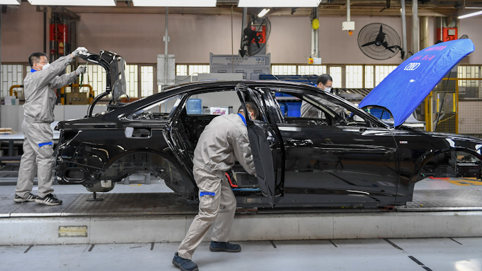 In this Feb. 17, 2020, file photo released by Xinhua News Agency, workers assemble Audi A6 L cars at a workshop of FAW-Volkswagen Automobile Co., Ltd. in Changchun, northeast China's Jilin Province.Factories that make the world's smartphones, toys and other goods are struggling to reopen after a virus outbreak idled China's economy. But even with the ruling Communist Party promising help, companies and economists say it may be months before production is back to normal.
