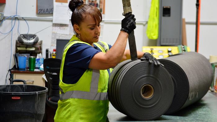 In this May 25, 2018 file photo, an employee at Acme Mills in Santa Teresa, N.M., works to organize textiles. Border trade leaders are expressing optimism for the 2020 trade forecast with Mexico, especially at the busy Santa Teresa Port of Entry in New Mexico, following the new free trade agreement.