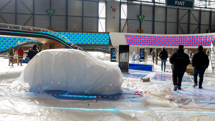 Workers dismantle a booth after that the 90th Geneva International Motor Show (GIMS) is cancelled by Swiss authorities, at the Palexpo in Geneva, Switzerland, Friday, Feb. 28, 2020. The 90th edition of the International Motor Show, scheduled to begin on March 5th, is cancelled due to the advancement of the (Covid-19) coronavirus in Switzerland. The Swiss confederation announced today that all events involving more than 1,000 people would be banned until 15 March.