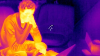 Image showing the difference in thermal radiation and temperature between a person and surfaces.