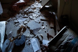 Houston Fire Chief Samuel Peña talks with Hortensia Lima, whose home was seriously damaged and deemed uninhabitable on Stanford Court in Houston, Sunday, Jan. 26, 2020, after the Friday morning explosion at the Watson Grinding Manufacturing plant.