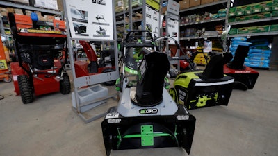 In this Jan. 27, 2020 photo snow blowers are lined up at a Home Depot store location in Boston.