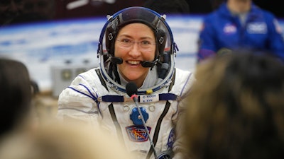 In this Thursday, March 14, 2019 file photo, U.S. astronaut Christina Koch, member of the main crew of the expedition to the International Space Station (ISS), speaks with her relatives through a safety glass prior the launch of Soyuz MS-12 space ship at the Russian leased Baikonur cosmodrome, Kazakhstan.