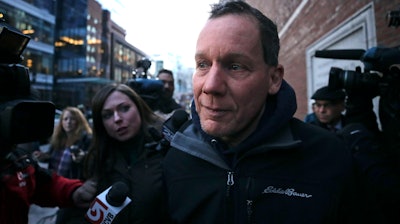 Harvard University professor Charles Lieber is surrounded by reporters as he leaves the Moakley Federal Courthouse in Boston, Thursday, Jan. 30, 2020. Leiber, chair of the department of chemistry and chemical biology, with lying to officials about his involvement with a Chinese government-run recruitment program through which he received tens of thousands of dollars.