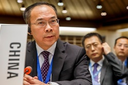 China's Ambassador Li Song asks the floor after moving a placard identifying his country, during the 146th session of the World Health Organization Executive Board, at the World Health Organization (WHO) headquarters in Geneva, Switzerland, Monday, Feb. 3, 2020.