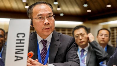 China's Ambassador Li Song asks the floor after moving a placard identifying his country, during the 146th session of the World Health Organization Executive Board, at the World Health Organization (WHO) headquarters in Geneva, Switzerland, Monday, Feb. 3, 2020.