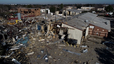 This Jan. 24, 2020, file aerial photo shows the scene of an explosion that rocked northwest Houston. A company filed for bankruptcy Thursday, Feb. 6, 2020, in the wake of a massive explosion at one of its warehouses in Houston that killed two workers, injured 20 more and damaged hundreds of buildings. Watson Grinding and Manufacturing said it filed for Chapter 11 bankruptcy in Houston federal court because of what it expects to be “a long-term interruption of business operations” due to the Jan. 24 blast.