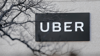 In this Nov. 15, 2019, file photo is an Uber office in Secaucus, N.J. Uber continued to lose cash as it poured money into building its food delivery business and developing technology for driverless cars, but revenue for its rides business nearly tripled as the company picked up more passengers around the world. The ride-hailing giant lost $1.1 billion in the fourth quarter of 2019, about 24% more than it lost at the same time last year.