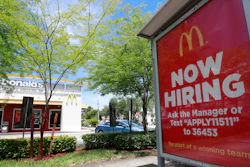 In this July 1, 2019, file photo, a help wanted sign appears on a bus stop in front of a McDonald's restaurant in Miami.