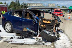 In this March 23, 2018, file photo provided by KTVU, emergency personnel work a the scene where a Tesla electric SUV crashed into a barrier on U.S. Highway 101 in Mountain View, Calif.