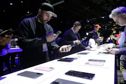 People look at different Samsung Galaxy S20 5G phones displayed at the Unpacked 2020 event in San Francisco, Tuesday, Feb. 11, 2020.