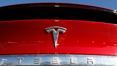 In this Feb. 2, 2020 file photograph, the company logo sits on an unsold 2020 Model X at a Tesla dealership in Littleton, Colo.
