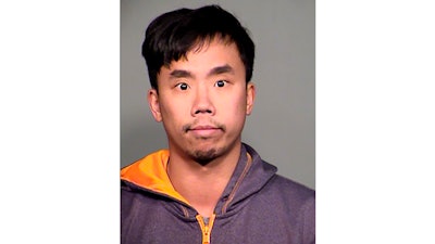 This undated booking photo provided by the Tempe Police Department shows Raymond Tang.
