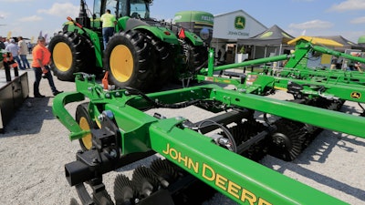 In this Sept. 10, 2019, file photo a John Deere tractor is on display at the Husker Harvest Days farm show in Grand Island, Neb. Deere & Co. reports earns on Thursday, Feb. 20, 2020.