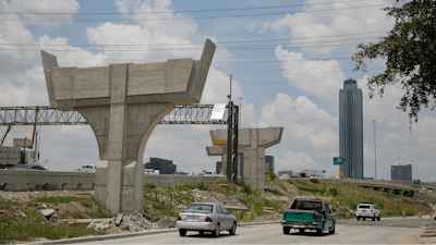 In this July 11, 2019 file photo, construction on the Interstate 69 and Interstate 610 interchange continues in Houston. In the midst of an election year, President Donald Trump has outlined a new $1 trillion infrastructure plan. This time, the Republican president is proposing to rely fully on federal spending to reach his goal, a fundamental change that is praised by some state transportation officials and industry groups, even though Trump's proposal doesn't spell out how to pay for it all.