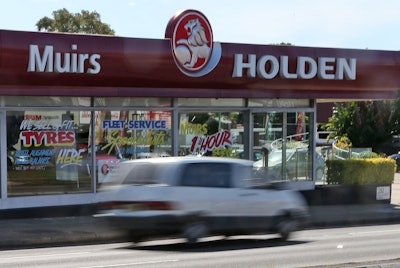 A car drives past a dealership of Holden, General Motors' Australian subsidiary, in Sydney, Dec. 11, 2013.