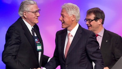 In this March 1, 2012 file photo, former President Bill Clinton shakes hands with Owen Bieber, left, with United Auto Workers union (UAW), at the 2012 UAW National Community†Action Program Conference, at the Marriott Wardman Park Hotel, in Washington. Bieber, who led the United Auto Workers union from the auto industry's dark days of the early 1980s to the prosperity of the mid-1990s, has died. He was 90.