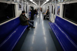 In this Feb. 17, 2020, file photo, commuters ride in a quiet subway train during the morning rush hour in Beijing.