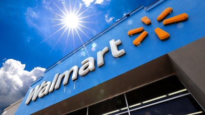 This June 25, 2019, file photo shows the entrance to a Walmart in Pittsburgh. Walmart is reporting disappointing fourth-quarter profits and sales. The nation's largest retailer says that sales at its U.S. stores heading into the holiday season were weaker than expected. It also said that social unrest in Chile hurt its business.