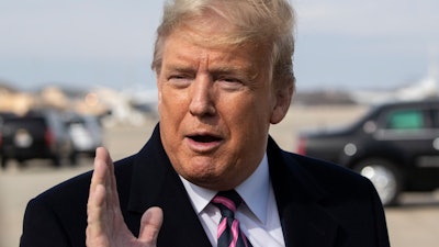 President Trump speaks with reporters as he boards Air Force One, Andrews Air Force Base, Md., Feb. 18, 2020.