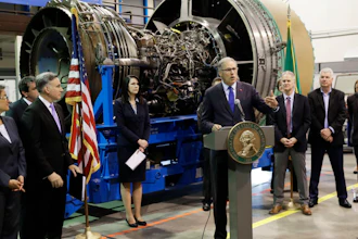 Washington Gov. Jay Inslee speaks in front of an airplane engine at South Seattle College, June 6, 2018.