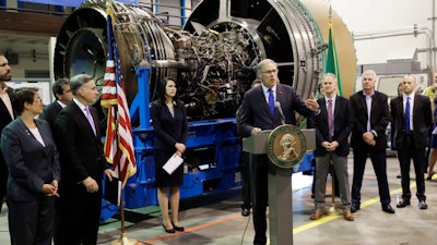Washington Gov. Jay Inslee speaks in front of an airplane engine at South Seattle College, June 6, 2018.