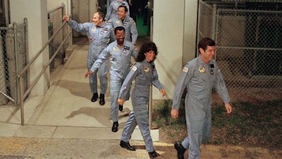 In this Jan. 27, 1986, file photo, the crew for the Space Shuttle Challenger flight 51-L leaves their quarters for the launch pad at the Kennedy Space Center in Florida. Mission Spl. Ronald McNair, center, was only the second African American chosen to go to space. He died in the Challenger launch. The documentary 'Black in Space: Breaking the Color Barrier' is scheduled to air on the Smithsonian Channel on Monday, Feb. 24, 2020, and examines the race to get black astronauts into space.