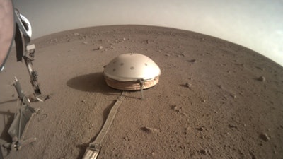 This Feb. 18, 2020 photo made available by NASA shows the InSight lander's dome-covered seismometer, known as SEIS, on Mars. On Monday, Feb. 24, 2020, scientists reported that the spacecraft has detected hundreds of quakes and even aftershocks that are regularly jolting the red planet.
