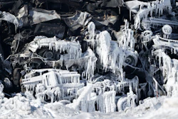 The massive fire at Northern Metal recycling in Becker, Minnesota, that has been burning for days, seemed to be under control Thursday, Feb. 20, 2020 with massive piles of burned cars covered in ice. The Becker Police Department posted Thursday that “major progress' has been made and that fire crews report the fire is “under control at this point.”