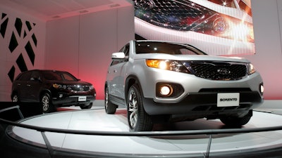 In this Dec. 2, 2009, file photo, the 2011 Kia Sorento debuts at the Los Angeles Auto Show in Los Angeles. Kia is joining its affiliate Hyundai in recalling thousands of vehicles in the U.S. because water can get into a brake computer, cause an electrical short and possibly a fire. The Kia recall covers nearly 229,000 Sedona minivans from the 2006 through 2010 model years. Also covered are Sorento SUVs from 2007 through 2009.