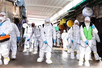 Workers wearing protective suits spray disinfectant as a precaution against the coronavirus at a market in Bupyeong, South Korea, Monday, Feb. 24, 2020. South Korea reported another large jump in new virus cases Monday a day after the the president called for 'unprecedented, powerful' steps to combat the outbreak that is increasingly confounding attempts to stop the spread.