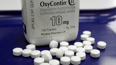 This Feb. 19, 2013, file photo shows OxyContin pills arranged for a photo at a pharmacy in Montpelier, Vt. OxyContin maker Purdue Pharma launched an ad campaign Monday, Feb. 24, 2020, to tell people harmed by their powerful prescription opioid where they can file claims against the company.