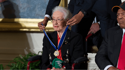 In this Nov. 24, 2015 photo, Willie Mays, right, looks on as President Barack Obama presents the Presidential Medal of Freedom to NASA mathematician Katherine Johnson during a ceremony in the East Room of the White House, in Washington. Johnson, a mathematician on early space missions who was portrayed in film 'Hidden Figures,' about pioneering black female aerospace workers, died Monday, Feb. 24, 2020.