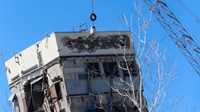 A wrecking ball smashes against the 'Leaning Tower of Dallas' north of downtown Dallas, Monday, Feb. 24, 2020. The still-standing structure is part of the 11-story former Affiliated Computer Services building that found a second life online after a Feb. 16 implosion attempt. The company that engineered the blast said some explosives did not go off.