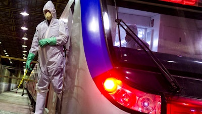Workers disinfect subway trains against coronavirus in Tehran, Iran, in the early morning of Tuesday, Feb. 25, 2020. Iran's government said Tuesday that more than a dozen people had died nationwide from the new coronavirus, rejecting claims of a much higher death toll of 50 by a lawmaker from the city of Qom that has been at the epicenter of the virus in the country.