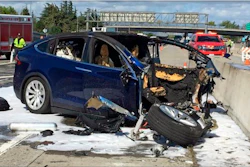 In this March 23, 2018, file photo provided by KTVU, emergency personnel work a the scene where a Tesla electric SUV crashed into a barrier on U.S. Highway 101 in Mountain View, Calif.