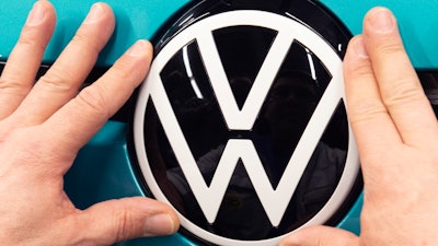 A worker completes an electric car ID.3 body at the assembly line during a press tour at the plant of the German manufacturer Volkswagen AG (VW) in Zwickau, eastern Germany, Tuesday, Feb. 25, 2020. Volkswagen are completely converting the plant in Zwickau from 100 percent combustion engine to 100 percent electric. Around 100,000 electric models are to be produced in Zwickau as early as next year.