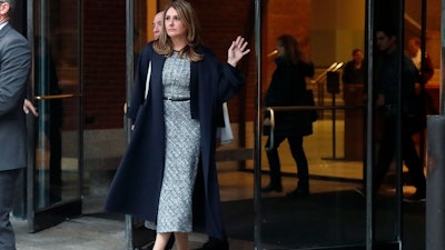 Michelle Janavs leaves federal court, Tuesday, Feb. 25, 2020, in Boston, after being sentenced to five months in prison for trying to cheat and bribe her daughters' way into college as part of a nationwide college cheating scam.