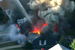 In this Sept. 13, 2018 file image from video provided by WCVB in Boston, flames consume the roof of a home following an explosion in Lawrence, Mass.